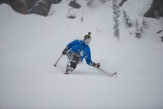 Trevor Kennison in the Eddie Bauer BC Flyline Kit he helped design to meet the needs of adaptive skiers who use a mono or bi-ski to participate in alpine skiing.