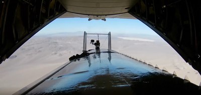 A Silent Arrow GD-2000 is deployed from a C-130 by rolling backwards and safely separating from the cargo ramp over an undisclosed desert test range.
