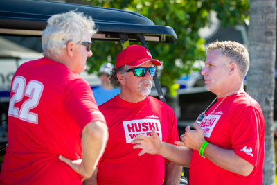 Throttleman Steve Curtis, Driver Carlos de Quesada, and Crew Chief Gary Stray work on strategy prior to racing.