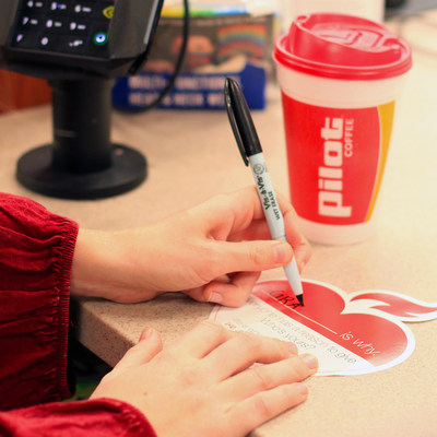 A guest purchases a red paper heart in support of the American Heart Association's Life is Why campaign at a Pilot Travel Center in Strawberry Plains, Tenn.