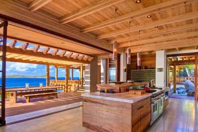 The Villa's main kitchen offers beautiful wood finishes and striking views of the crystal blue Atlantic Ocean. Exotic woods are used throughout the Villa, such as western red cedar beams, Ipe flooring and Sapele framing. Learn more at BVILuxuryAuction.com.