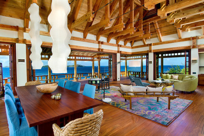 The grand salon (shown here) is located in the largest of the Villa's four living quarters. Lovely, exposed beams in western red cedar rise overhead, while sublime ocean views envelope the living space. The custom-built residence was designed by world-renowned architectural firm OBM International, with lighting, landscaping and gardens designed by Kurisu International. Visit BVILuxuryAuction.com for details.
