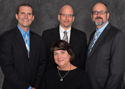 Richard Dearing (standing center), retiring after 27 years as President/CEO of Dearing Compressor and Pump, is joined by Becky Wall Dearing (seated) and Albin Dearing (right), Dearing's new CEO and President, respectively.  Also in the picture is Ryan Wilson (left), current Vice President, representing the 4th generation of the family leaders in the company for more than 75 years.