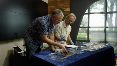 Dwight Manley, Managing Partner of the California Gold Marketing Group, and Bob Evans, Chief Scientist of the SS Central America recovery efforts, examining the coins.