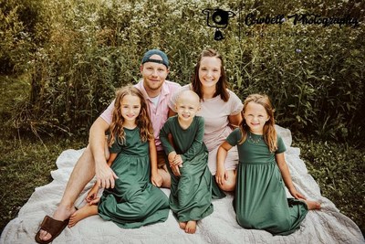 Four-year-old Milah Schevenius (middle) with her family. Image courtesy of Cowbell Photography by Macy Baker.