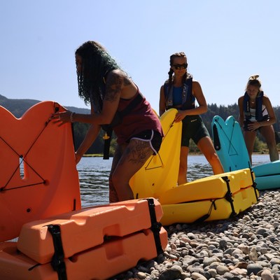 Three women unfold their Origami Paddlers as they prepare for an aquatic adventure. (PRNewsfoto/Origami Paddler)