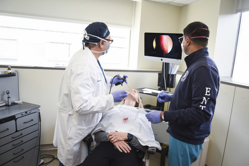 Dr. David Rosen (left), Nancy Damato (center), and Dr. Glen D'Souza (right). Dr. Rosen is using an endoscope to place the topical platelet-rich plasma (PRP) on the olfactory nerve in Nancy's nose. The PRP is mixed with a dissolving sponge and is a painless procedure.