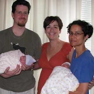 Mark, Rachel, and Mark's wife Tina with the twin girls born via Rachel's surrogacy.