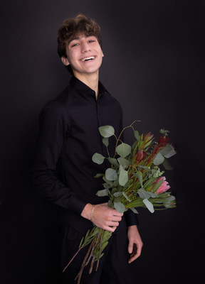 Dylan holding a bouquet of flowers he made.