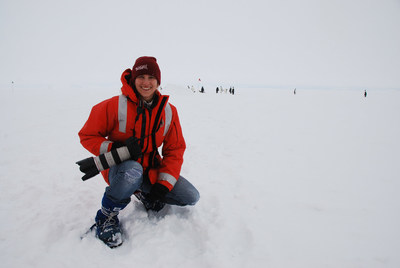 Cassandra Brooks, Ph.D. with Emperor Penguins, Photo by Christina Riesselman