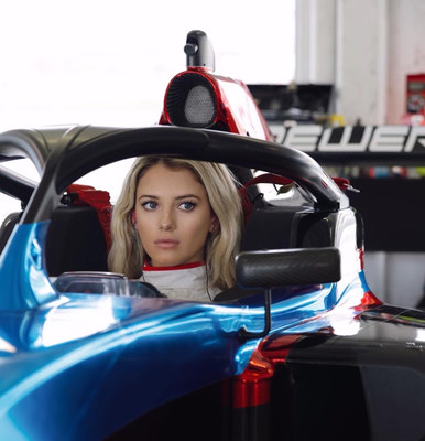 24-year-old Lindsay Brewer sits in a Tatuus IP-22 single-seat open-wheel Indy car-style racecar.