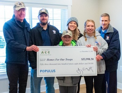 Eric Norrington, SVP of Public Affairs at Populus Financial Group presents a $53,998 donation to Bill Ivey, Executive Director at Homes For Our Troops and to Marine Lance Corporal Bobby McCardle and his family