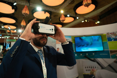 A summit delegate exploring a Virtual Reality (VR) device at the WISH 2018 Innovation Hub