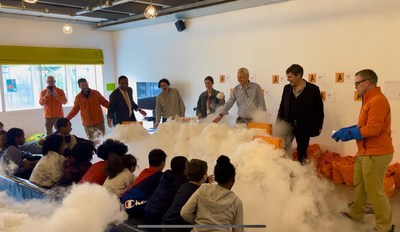 Representatives from COSI and Virgin create a hands-on science experiment featuring dry ice.