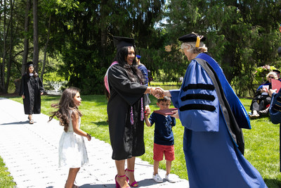Army vet Tanya Marie Painter, joined by family, about to receive her diploma from Vassar College President Elizabeth H. Bradley at Commencement in 2019.