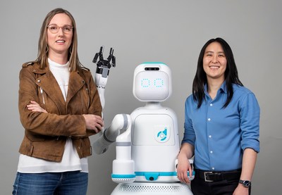 Diligent Robotics co-founders, Dr. Andrea Thomaz and Dr. Vivian Chu pose with Moxi, a robot they created to help take the stress off of nurses and clinical care teams so they can spend more time with their patients.