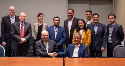 Pictured from Hughes (standing left to right), Dean Manson, Paul Gaske, Sharyn Nerenberg, Francis Selvadoss, Ramesh Ramaswamy and Vaibhav Magow, with Hughes President and CEO Pradman Kaul (seated left) shaking hands with PSN CEO Adi Rahman Adiwoso, and, behind him, from PSN (left to right), Anggarini Surjaatmadja, Satrio Adiwicaksono and Ravi Talwar.