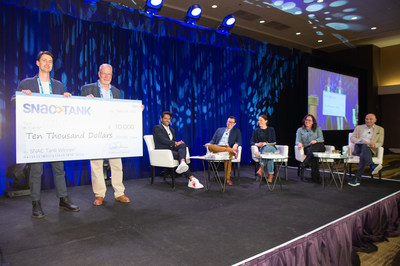 Candid snack company founder and CEO Chris Kajander receives the $10,000 grand prize for his pitch to SNAC Tank highlighting the sustainability of his company's Noons™ cacao bites snack