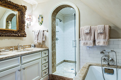 This lovely guest bath includes a soaking tub and large, walk-in steam shower. Fine marble and tile finishes are used throughout each of the residence's bathrooms (totaling 7 full and 3 half baths). DurangoLuxuryAuction.com.