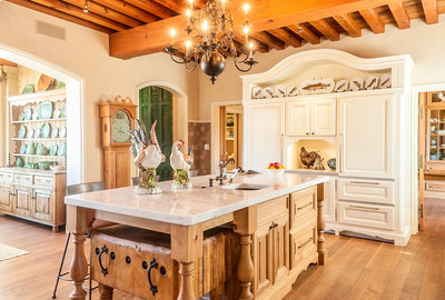 The gourmet kitchen is where fine finishes meet functionality: beautifully exposed wooden beams rise above top-of-the-line appliances. A large prep/catering area (not pictured) is adjacent to the kitchen. More details at DurangoLuxuryAuction.com.