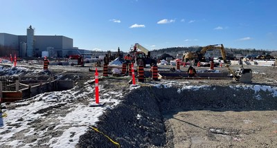 Crews working within the foundation walls of the new solvent extraction building, installing support for SX tanks and steel structures. Existing refinery building can be seen in the background. (CNW Group/Electra Battery Materials Corporation)
