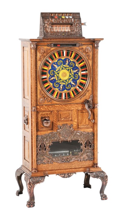 Very rare circa 1902 Watling musical 'Puck' 5 cent vertical slot machine with quartered oak cabinet, lithographed Puck wheel, all original castings and original music feature.  Originally owned by boxing legend Jack Dempsey's training partner, Eddie Bohns.  Estimate $30,000 to $50,000