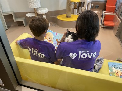 Kids reading to shelter cats at Los Angeles Animal Services during the "Read and Share Your Love" event.