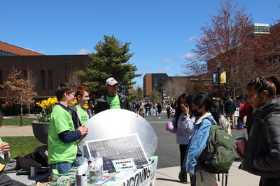 University of Connecticut students learn about Renogy and the STEAM Tree, UConn's first solar panel tree, at the Earth Day celebration.