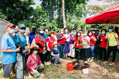 Members of the Woodgrove/Singapore American School community garden gather with local MP Ms. Hany Soh