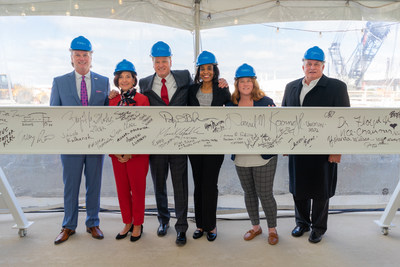 Ford International Airport's Board of Directors signs their names on a ceremonial beam to celebrate the expansion of Concourse A.