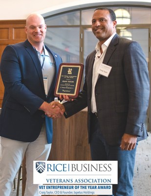 Nicholas Sauls from the Rice Business Veterans Association (left) at Rice University’s Jones Graduate School of Business hands Craig Taylor, CEO of Iapetus Holdings (right), the 2022 "Veteran Entrepreneur of the Year" Award.