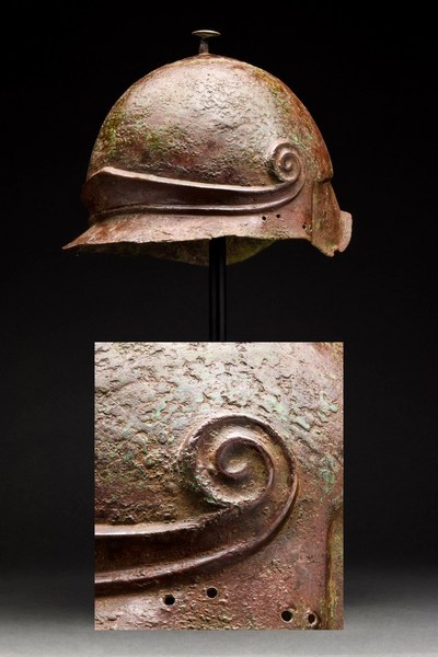 Extraordinary Greek Attic helmet of domed form, circa 300 BC, hammered bronze, exhibits craftsmanship and artistry of a very high standard. Similar examples appeared in Christie's auction of Axel Guttman collection. Provenance: London private collector; European collection; Peter Ing; old Austrian collection. Estimate £60,000-£90,000 ($74,695-$112,040)
