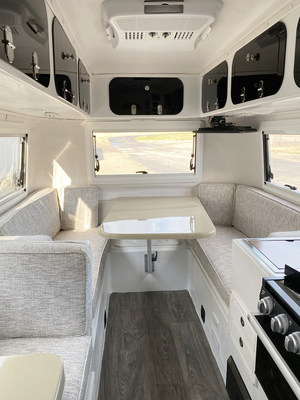 Cortes Campers 17-ft travel trailer has a full kitchen, wet bath, and entertainment center in a small living space. The panoramic view with windows on 3-sides gives the camper an air of openness.