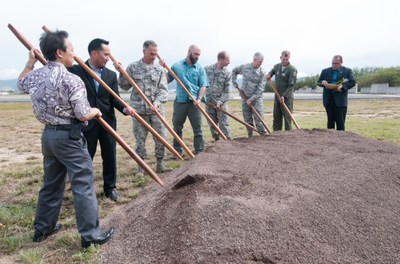 Glen Kaneshige, President of Nordic PCL Construction in Honolulu, participates in a groundbreaking ceremony using traditional Hawaiian ʻōʻōsticks. Photo by Senior Airman Robert Cabuco. (CNW Group/PCL Construction)