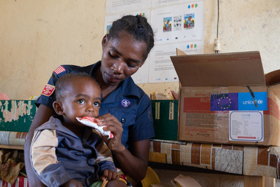 On 4 March 2022 in Bevoalavo village, Madagascar, Sanasoanandrasana, 25, holds her 2-year-old son Razafimandimby while he eats a Ready-to-use therapeutic food (RUTF). (CNW Group/UNICEF Canada)