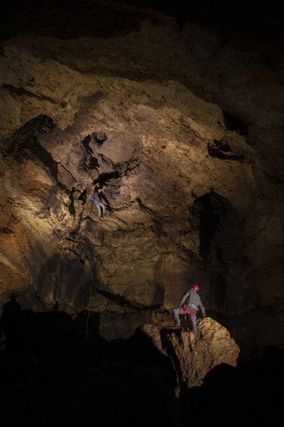 Brad Wuest watches as T. Dexter Soechting descends from the entrance into Goliath’s Dome for the first time. Photo Courtesy of Natural Bridge Caverns, shot by Bennett Lee.