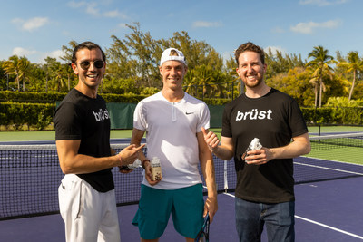 Denis Shapovalov (center), along with co-founders Amar Gupta (left) and Josh Barr (right) (CNW Group/Brust Beverage Company, Ltd.)