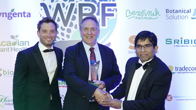 Chris Johnson of FMC (center) accepts the Best Biostimulant Product award at the 2022 World BioProtection Awards for FMC's Accudo® biostimulant