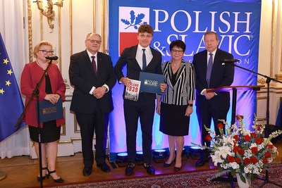 A scholarship recipient receives his award