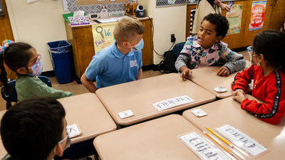 P.S. 60 students discuss sentence structure with a visiting Welsh student (center). (PRNewsfoto/The Writing Revolution)