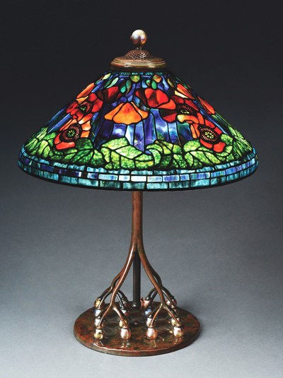 Tiffany Studios table lamp with 20in conical leaded-glass shade in 'Poppy' motif exhibiting the very highest standards of Tiffany artistry. Astounding colorway and complex composition. Exceptionally rare base with 16 iridescent Favrile-glass balls as supports for the telescoping stem. Tiffany stamps to both shade and base. Estimate $350,000-$450,000