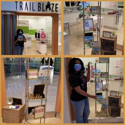 April Pelton staying safe next to her display, while promoting her books at Trail Blaze Shops!