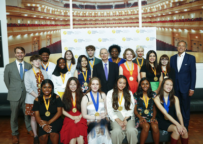 Executive Director of the Alliance for Young Artists & Writers, Christopher Wisniewski, CEO of Scholastic, Peter Warwick, and Chairman of the Board of the Alliance for Young Artists and Writers, Hugh Roome, stand alongside Gold Medal Portfolio recipients backstage at the 2022 Scholastic Art & Writing Awards National Ceremony held at Carnegie Hall, New York, N.Y., Thursday, June 9, 2022. (Photo by Stuart Ramson/AP Images for Alliance for Young Artists & Writers)