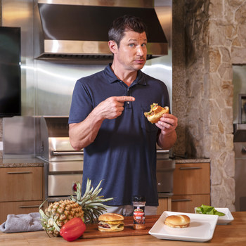 Nick Lachey enjoys his new Hawaiian Burger with Grilled Pineapple recipe created in partnership with McCormick Grill Mates (Photo Credit: Ryan Siphers)