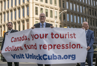 Orlando Gutirrez Boronat, centre, from the Assembly of the Cuban Resistance, stands in front of the Cuba Tourist Board of Canada in Toronto, June 14, with Ren Bolio, left, Mexican attorney and chairman of the Justice Cuba Commission and Luis Ziga Rey, human rights activist and a political prisoner who lived through 19 years of jail time in Cuba. The group travelled to Toronto to help promote freedom to the oppressed people of Cuba. (CNW Group/Assembly of the Cuban Resistance)