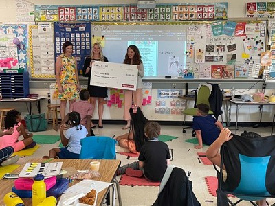 Anna Britt (R), of Glenn Elementary School in Durham, receives her award from (L) Michelle Atwell (First Bank Branch Manager, Raleigh) and Kelli Jarman (First Bank Branch Manager, Apex), along with her students.