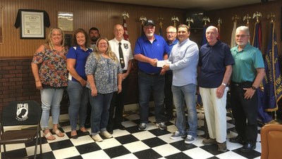 Felman Production Plant Manager Vitaliy Anosov presents a donation on behalf of the company to the American Legion Post 23 to support the Mason County Veterans Memorial.