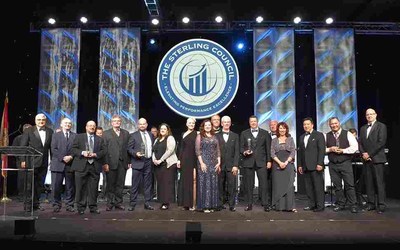 Harmar joins other winning manufacturers on stage at the Sterling Conference Awards Banquet after accepting the Silver Manufacturing Business Excellence Award.