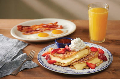 Cracker Barrel introduces new Stuffed Cheesecake Pancake Breakfast, featuring two buttermilk pancakes layered with a creamy cheesecake filling, topped with fresh seasonal fruit and powdered sugar, and strawberry syrup on the side. The meal is served with two eggs plus choice of Thick-Sliced Bacon or Smoked Sausage. Learn more at crackerbarrel.com.