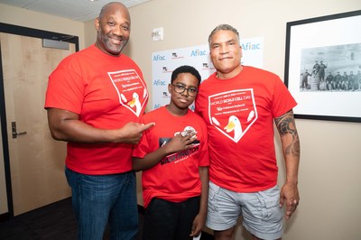Paxton Baker (r), Chairman of the Founding Partners Group for the Washington Nationals baseball team, poses with 10 year old sickle cell patient Kendric Comer and Aflac Senior Vice President Brad Knox during Aflac’s commemoration of World Sickle Cell Day with patients from Children’s National Hospital during a Washington Nationals baseball game in the nation's capital.
